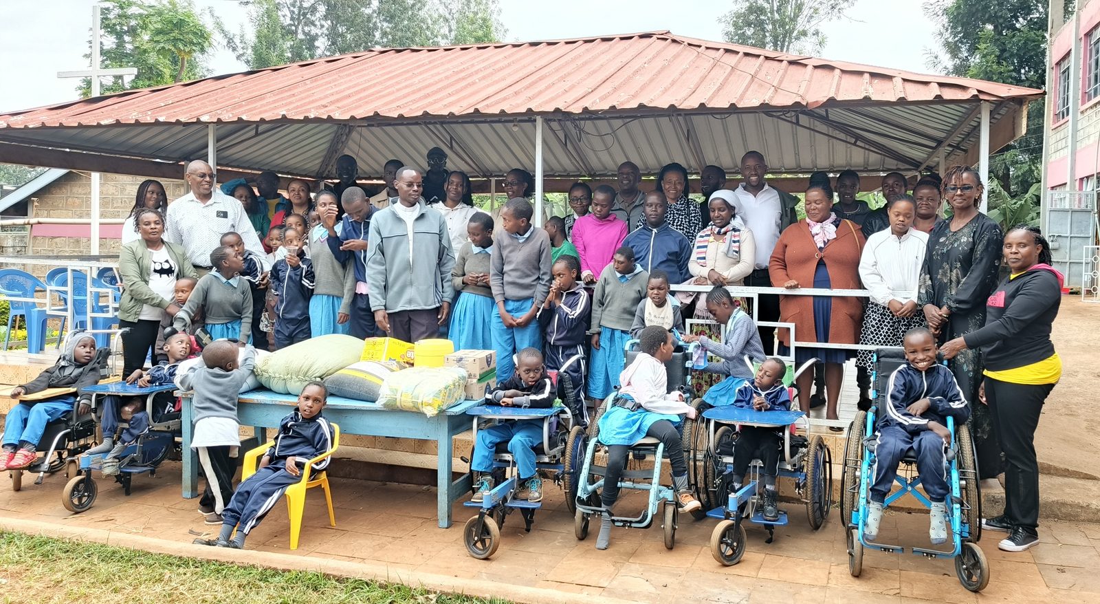 Children and young people at the Don Orione Centre, Kaburugi, with their families and carers